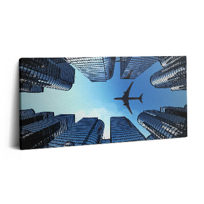 Imprimare tablou canvas 120x60 Avion deasupra clădirilor