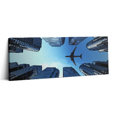 Print pe canvas 125x50 Avion deasupra clădirilor