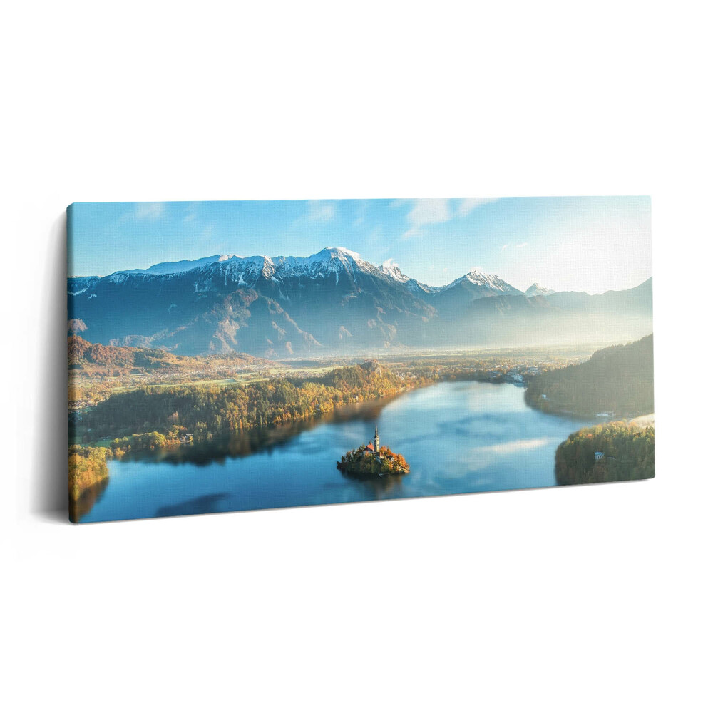 Print pe pânză 140x70 O clădire pe un lac în munți