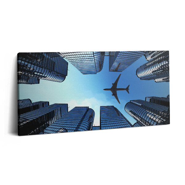 Print pe pânză 140x70 Avion deasupra clădirilor