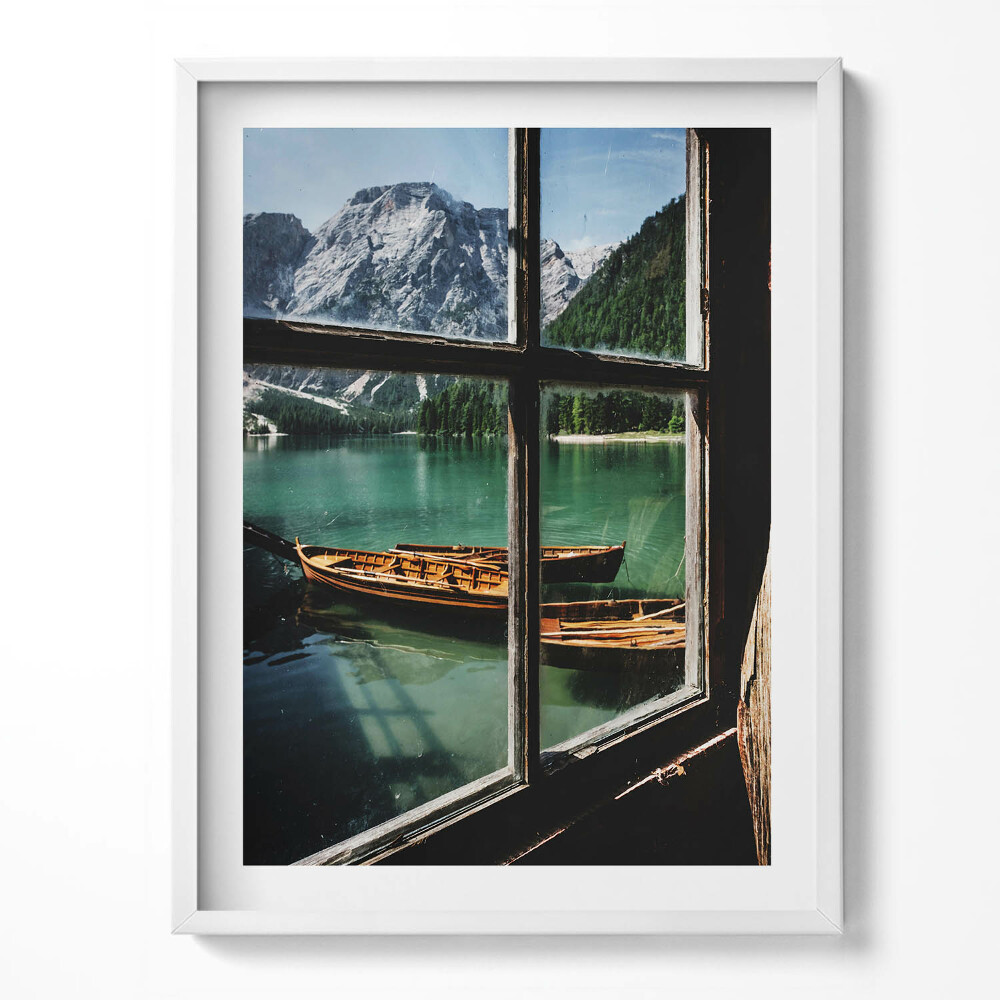 Tablou living cu rama O vedere de la fereastră spre un lac cu o barcă