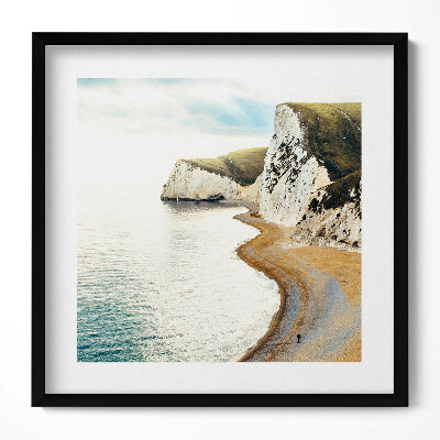 Tablou living cu rama unic O plajă liniștită la poalele stâncilor