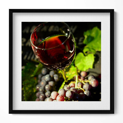 Tablou living cu rama unic Un pahar de vin roșu și struguri