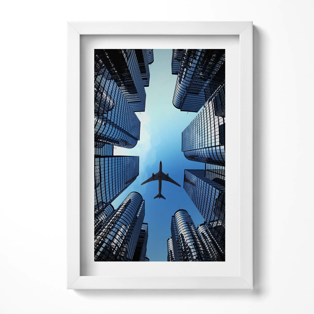 Tablou rama decorativ Avion deasupra clădirilor