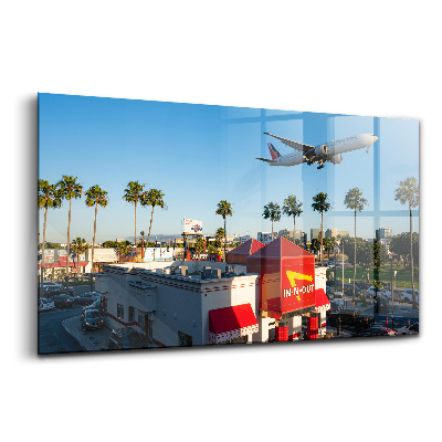Tablou din sticlă Avion decolează deasupra orașului Los Angeles
